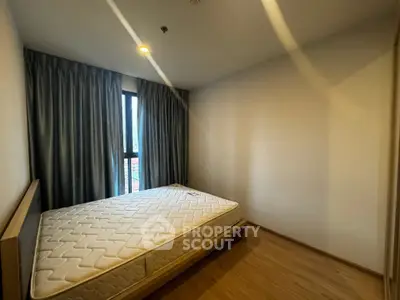 Spacious bedroom with natural light and modern design in prime real estate location.