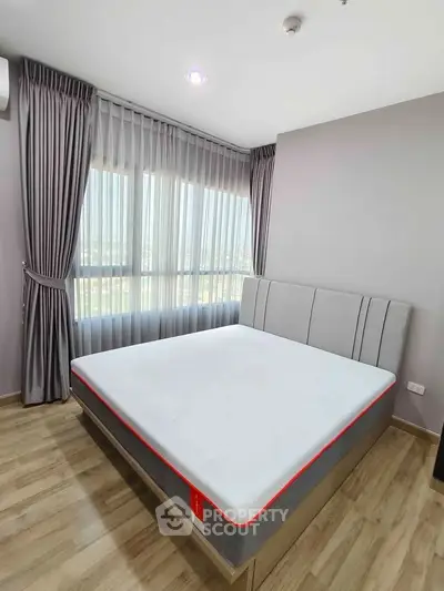 Modern bedroom with large window and stylish curtains