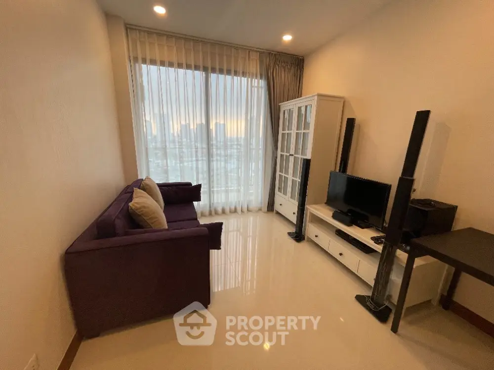 Modern living room with sleek furniture and large window offering city view.