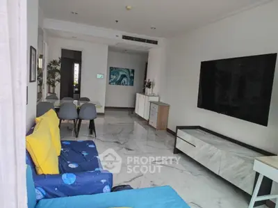 Spacious modern living room with marble flooring and large TV