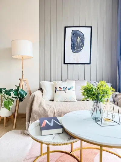 Stylish modern living room with cozy sofa, elegant decor, and chic coffee tables.