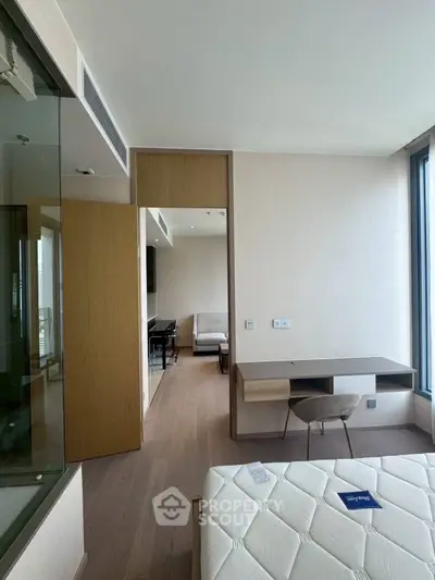 Modern bedroom with large windows and stylish furniture in a high-rise apartment.