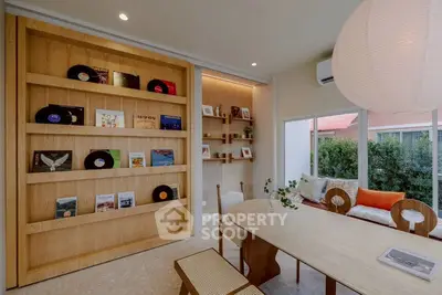 Chic living room with stylish wooden shelving and cozy seating area, perfect for relaxation and entertainment.