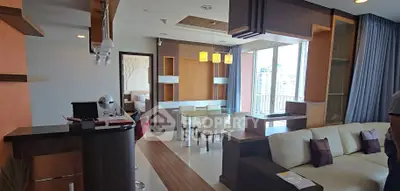 Modern open-layout living room with dining area and city view, featuring contemporary furniture and stylish decor.