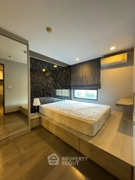 Modern bedroom with stylish decor and natural light