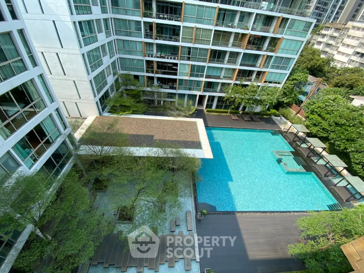 Luxurious modern apartment complex with stunning pool and lush greenery