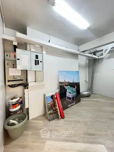 Spacious storage room with modern flooring and electrical panels