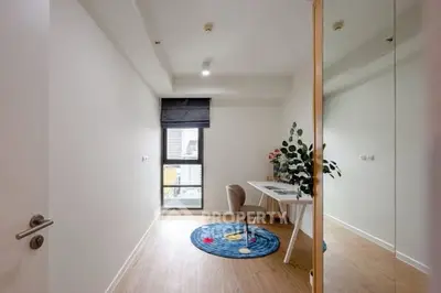 Modern study room with sleek desk and chair, large window, and decorative rug.