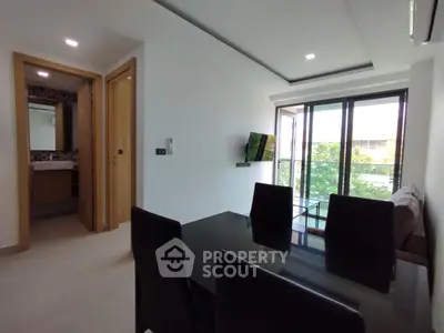 Modern living room with dining area and balcony view in a stylish apartment.
