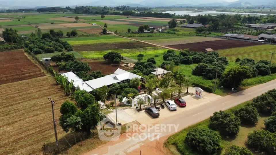Aerial view of a rural property with lush farmland and scenic surroundings.