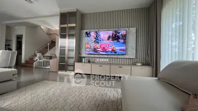 Spacious modern living room with stylish decor and large TV