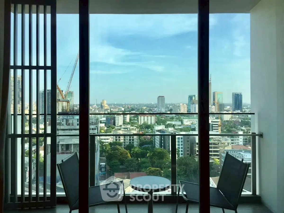 Stunning cityscape view from modern balcony with seating area