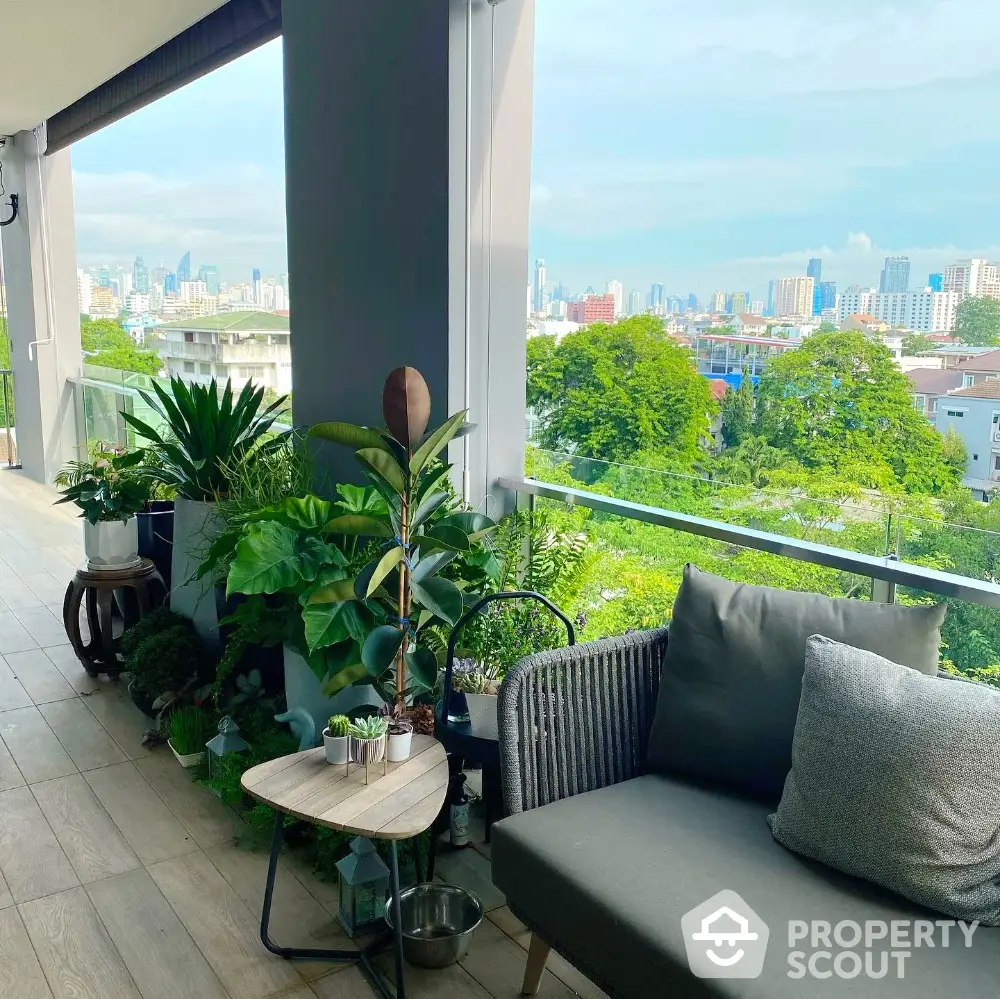 Spacious balcony with lush greenery and stunning city view, perfect for relaxation and entertaining.