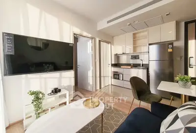 Modern living room with sleek kitchen and stylish decor