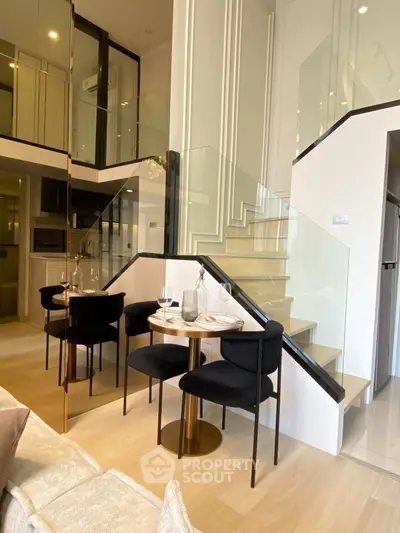 Elegant duplex interior with modern staircase and cozy dining area