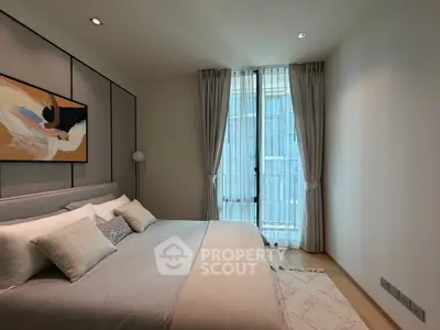 Luxurious bedroom with modern decor and large window in upscale apartment