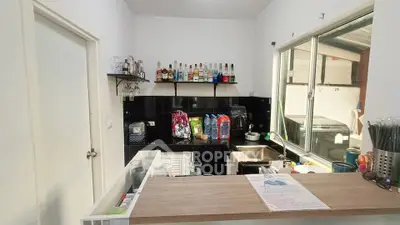 Charming kitchen with open layout and modern appliances, perfect for culinary enthusiasts.