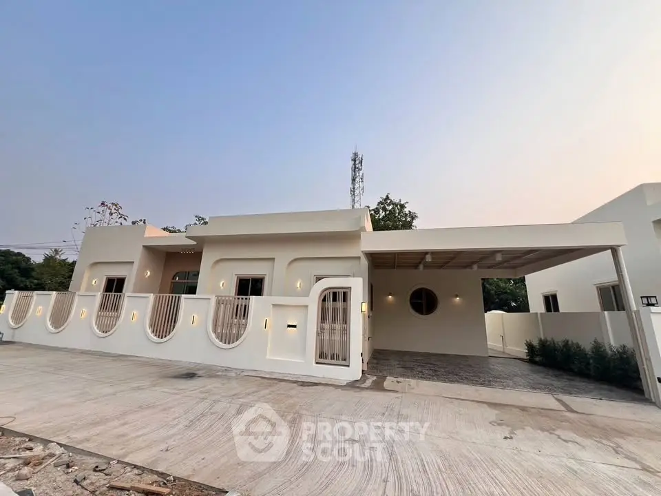 Modern single-story house with unique architectural design and spacious driveway.