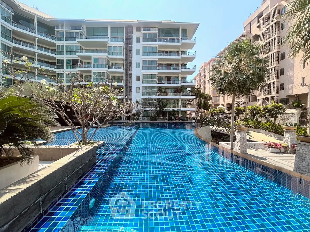 Luxurious condominium with stunning pool and modern architecture, perfect for upscale living.
