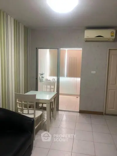 Cozy living room with modern decor and air conditioning, perfect for relaxation.