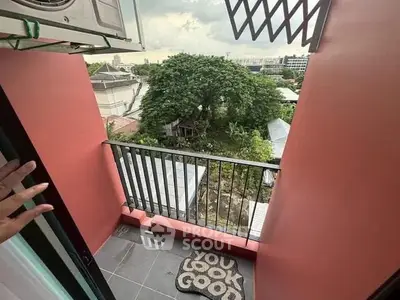 Charming balcony with scenic view and stylish decor in modern apartment.