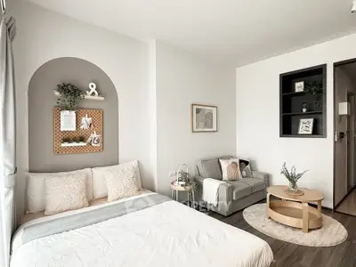 Modern cozy bedroom with stylish decor and comfortable seating area