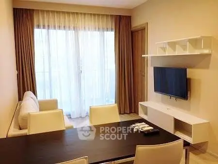 Modern living room with sleek furniture and large window for natural light.