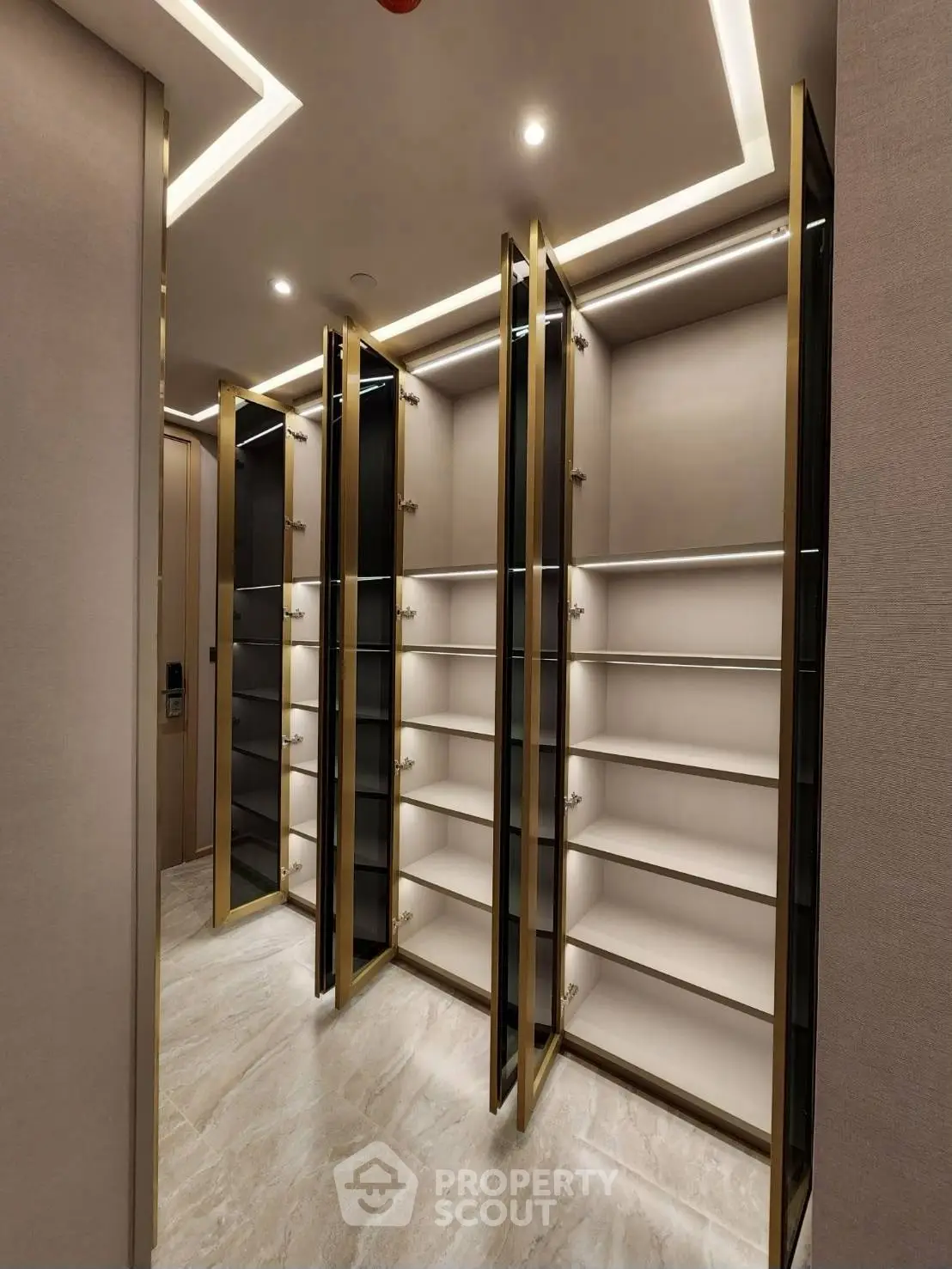Luxurious walk-in closet with elegant lighting and ample shelving space