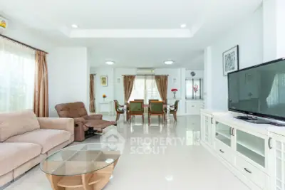 Spacious living room with modern furniture and large windows in a bright home