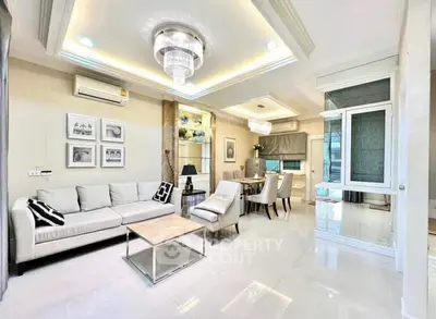 Luxurious modern living room with elegant chandelier and spacious seating area