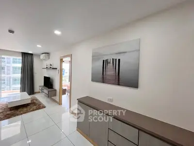 Modern living room with sleek furniture and large window view