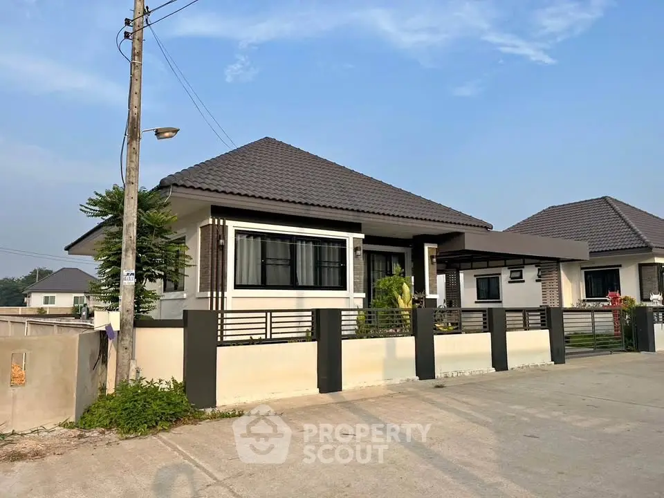 Charming single-story house with modern design and spacious driveway in a serene neighborhood.