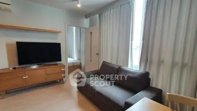 Modern living room with sleek furniture and large window