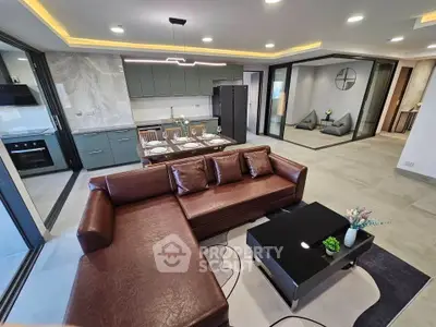Luxurious open-plan living room with modern kitchen and stylish decor
