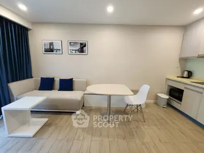 Modern living room with stylish furniture and open kitchen layout, perfect for urban living.