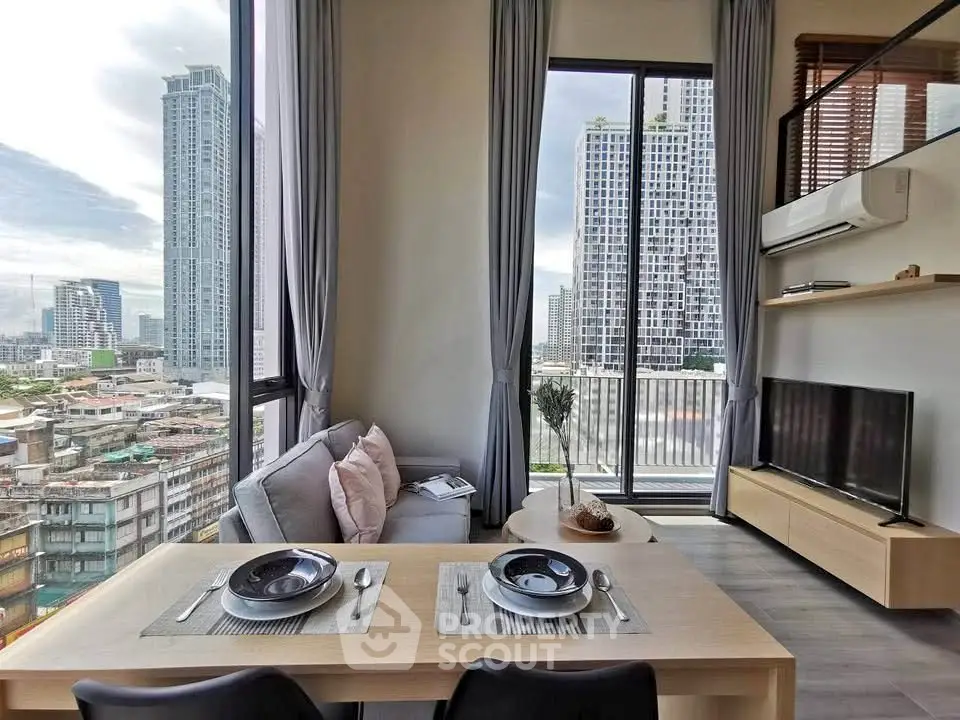 Modern living room with city view, featuring sleek furniture and large windows.