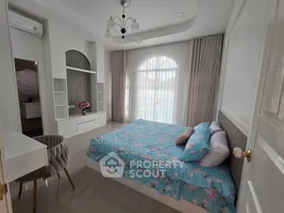 Elegant bedroom with large window and stylish decor