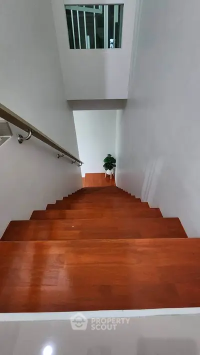 Elegant wooden staircase with sleek railing in modern home interior