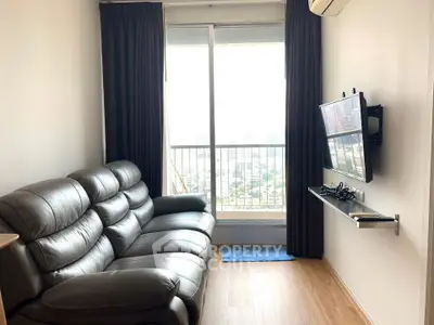 Modern living room with leather sofa and city view from balcony, perfect for urban living.