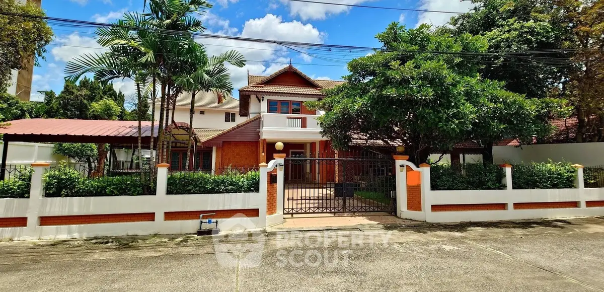 Charming suburban house with lush garden and gated entrance, perfect for family living.