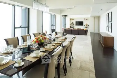 Luxurious open-plan dining and living area with elegant decor and ample natural light.