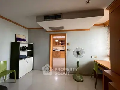 Spacious room with modern decor and open view into kitchen area