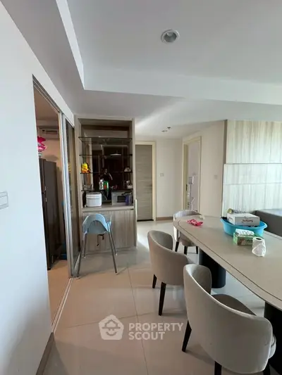 Modern dining area with sleek furniture and open layout in a contemporary apartment.