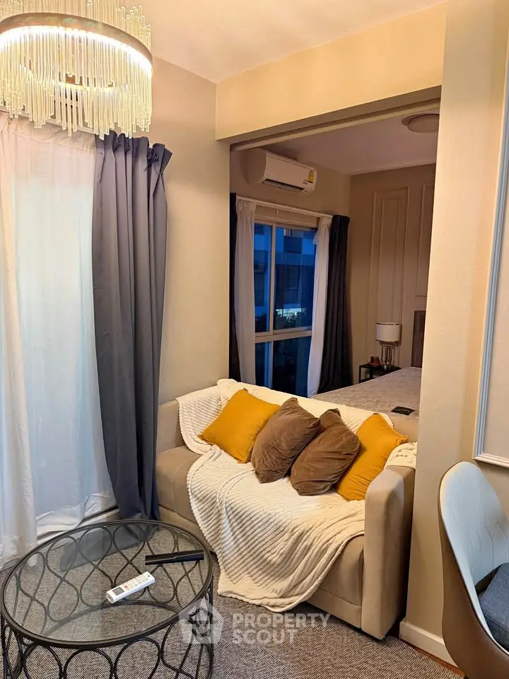 Cozy living room with modern decor and stylish lighting, featuring a comfortable sofa and elegant curtains.