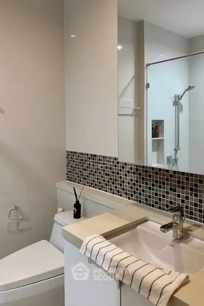 Modern bathroom with sleek fixtures and stylish tile accents.