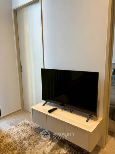 Modern living room with sleek TV stand and cozy carpet