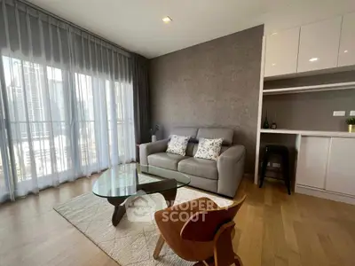 Modern living room with stylish furniture and city view through large windows.