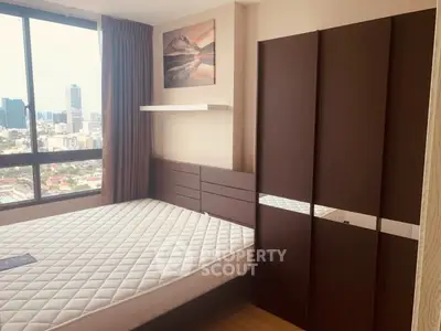 Modern bedroom with city view, featuring a large window, stylish wardrobe, and comfortable bed.
