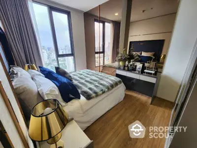 Luxurious bedroom with city view, elegant decor, and modern furnishings in high-rise apartment.