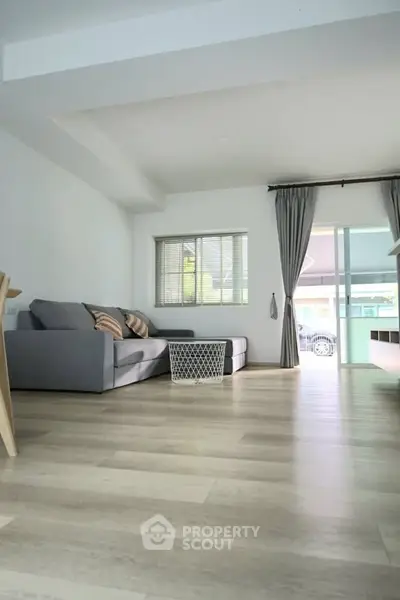 Spacious modern living room with sleek design and large windows for natural light.